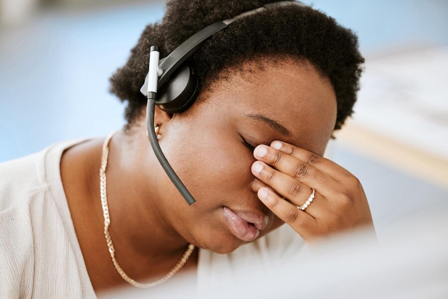 stressed and tired woman in a call center that is known for agent turnover
