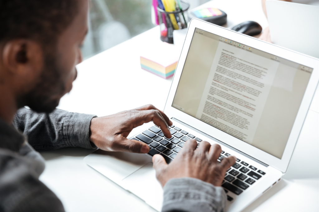 Man working on a task on his laptop at work