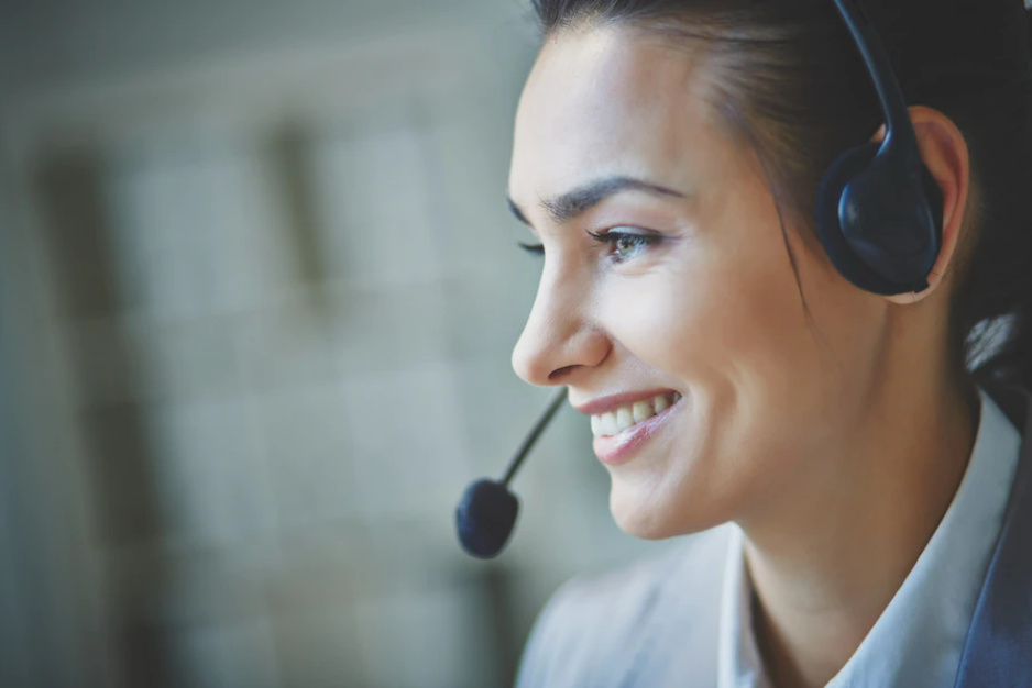 A woman working in a call center on a call with a customer using a headset, achieving customer success in digital transformation