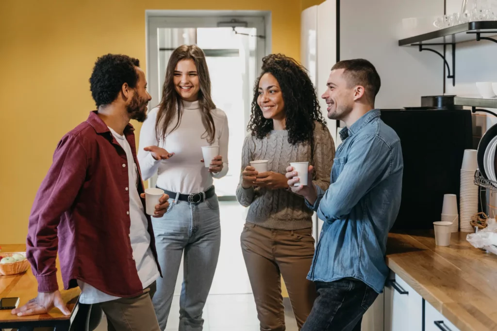 A group of employees chat together during break time at work