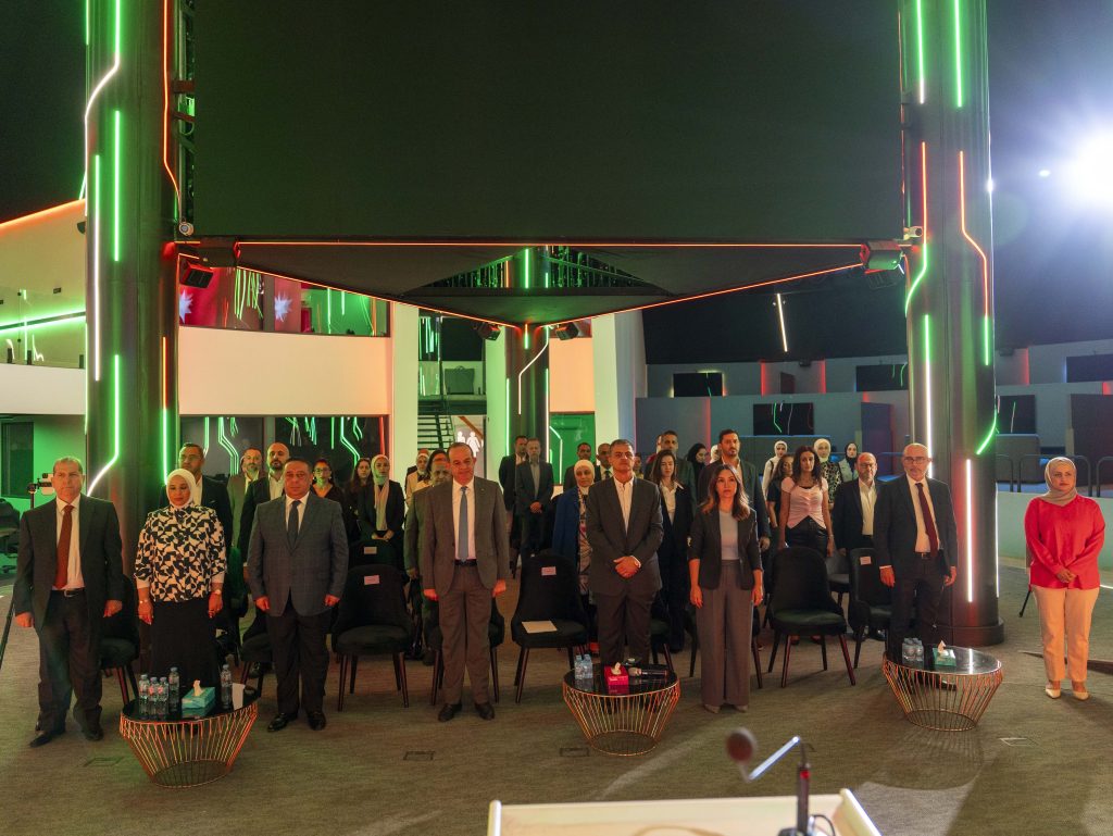 Many individuals stand by chairs at Ministry of Digital Economy and Entrepreneurship," and "Youth Technology Hub." One woman in the center holds a document. The setting appears to be a formal event, likely a signing ceremony or grant award. This image represents Avertra winning a grant from the Ministry of Digital Economy and Entrepreneurship (MoDEE) to upskill Jordan's youth in ICT